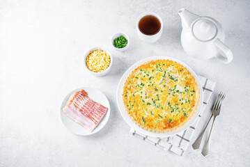 Bacon quiche with cheese and scallions in a plate