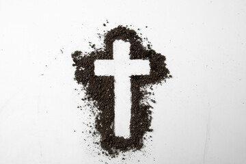 top view of cross shape with dark soil on the white surface soil death funeral grim reaper