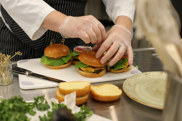 Chef Plating Sous Vide Burgers Dish in Commercial Kitchen 