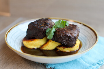 Sous Vide Plated Boneless Braised Short Rib, Red Wine Reduction, served over a Grilled Polenta Corn Meal Cake