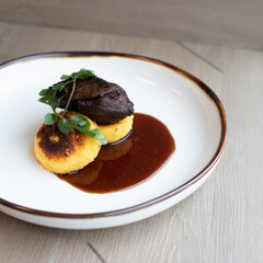 Sous Vide Plated Boneless Braised Short Rib, Red Wine Reduction, served over a Grilled Polenta Corn Meal Cake