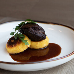 Sous Vide Plated Boneless Braised Short Rib, Red Wine Reduction, served over a Grilled Polenta Corn Meal Cake
