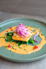 Sous Vide Plated Salmon, Bed of Wilted Spinach,
Tomato Cream Sauce, Wilted Garlic Spinach