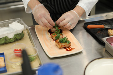 Chef Plating Sous Vide Red Wine Braised Pork Shoulder in Commercial Kitchen 