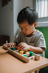 Young child, Asian boy, playing quietly with wooden toys, surrounded by a peaceful atmosphere. AI generative illustration of Montessori study materials