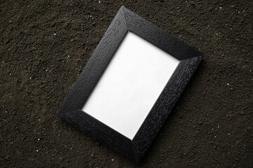 top view of picture frame on the dark soil death grim reaper funeral