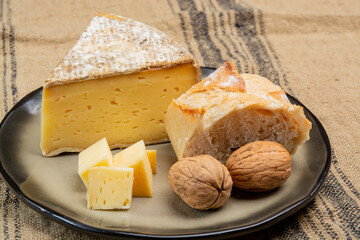 Pieces of cheese tomme de montagne or tomme de savoie made from cow milk in French Alps close up