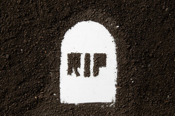 top view of rip inscription on grave shape with dark soil grim reaper death funeral devil