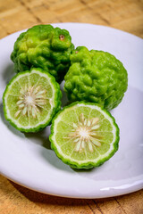 Citrus hystrix, kaffir lime citrus fruit native to tropical Southeast Asia. Fruit and leaves used in Southeast Asian cuisine, essential oil is used in perfumery for intense citrus fragrance.