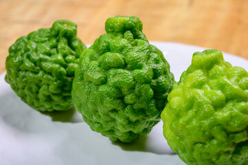 Citrus hystrix, kaffir lime citrus fruit native to tropical Southeast Asia. Fruit and leaves used in Southeast Asian cuisine, essential oil is used in perfumery for intense citrus fragrance.