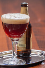 Glass of Belgian abbey brown beer in bar