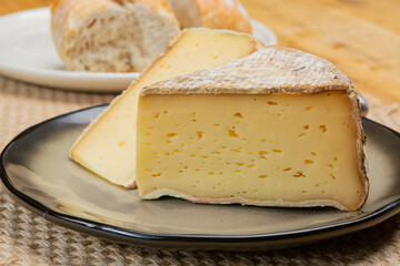 Pieces of cheese tomme de montagne or tomme de savoie made from cow milk in French Alps close up