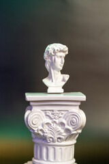 miniature Roman bust perched on column or pedestal