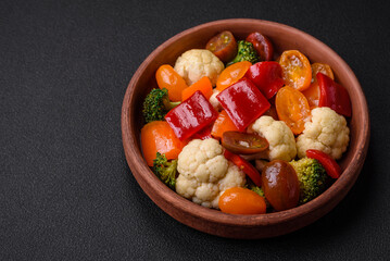 Delicious salad of fresh cherry tomatoes, sweet peppers, broccoli and cauliflower