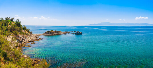 Fototapeta na wymiar Panoramic view of rocks and blue water near Kavala, Greece, Europe