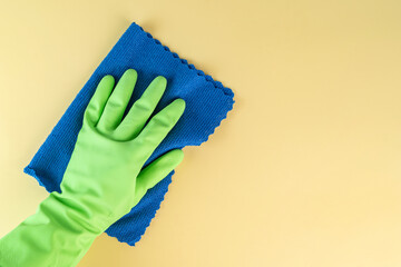 Green rubber gloves and a micro fiber towel, cleaning and housekeeping concept, copy space for...