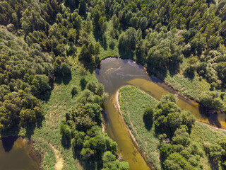 Aerial view of a small meandering river in a beautiful rural  landscape