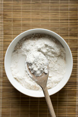 All purpose flour in a wooden spoon, baking flour in a spoon