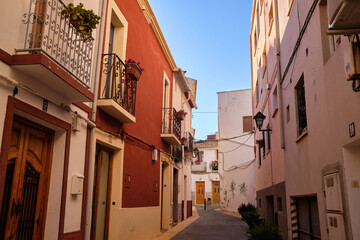View of colorful buildings and narrow streets, architecture in the historic center of the Mediterranean town of Calpe. Region Valencia in Spain
