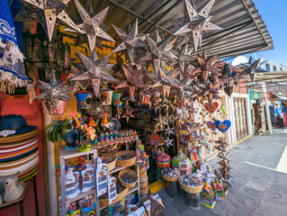 Artisan Mexican crafts for sale in an outdoor shopping alley