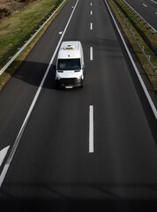 White delivery van on the highway. White modern delivery small shipment cargo courier van moving...