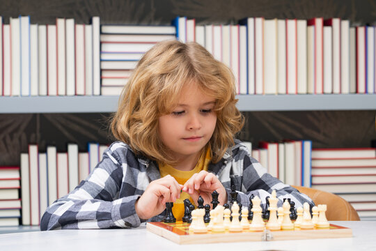 Chess school. Kid playing chess. Child thinking near chessboard. Learning and growing children, childgood. Kids early development.