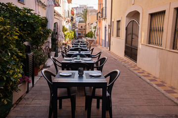 Historic center of the old town of Calpe.Calpe town with colorful houses and restaurant terraces.A place to eat in restaurants on a terrace street.Spain
