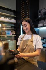 Joyous female cashier working in a cafe