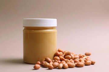 peanut butter and raw peanuts on a colored background