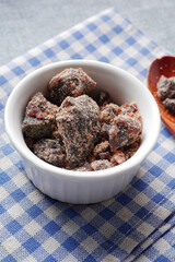 Himalayan black salt rock crystals, Kala Namak in a container on table 