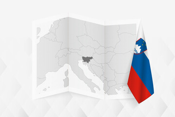 A grayscale map of Slovenia with a hanging Slovenian flag on one side. Vector map for many types of news.