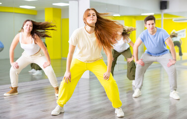 Fototapeta na wymiar Sports girl teenager rehearsing modern dances in dance hall