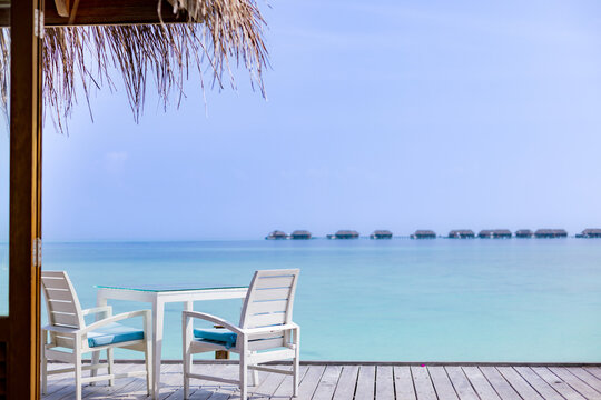 table and chairs on the terrace overlooking the Maldives atoll