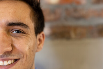 Half face portrait close up of happy caucasian casual businessman smiling, copy space