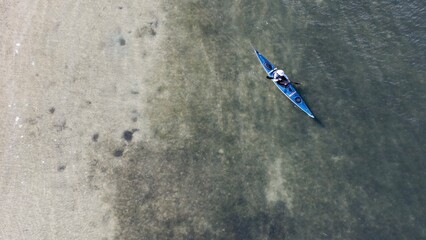 An aerial drone photo of kayaking in the green waters of Dunedin Causeway Tampa Bay, Florida.
