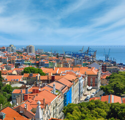 Fototapeta na wymiar Sea port with cranes view and cityscape from Monastery roof in Lisbon, Portugal.