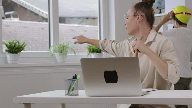 Young mother is working at laptop. Homeoffice