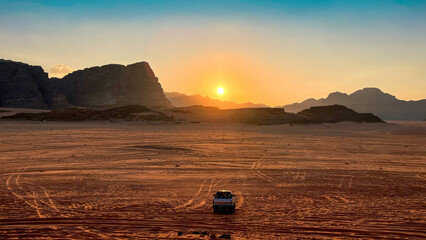 Safari in Wadi Rum desert, Jordan, Middle East. Tourists in the car ride on off-road on sand among...