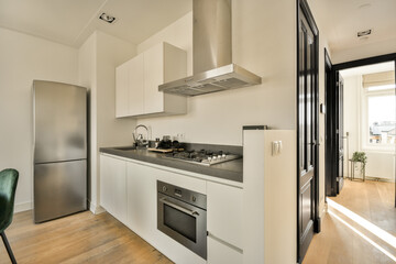 a kitchen with white cabinets and black counter tops on the island in front of the sink is an oven, stove and dishwasher