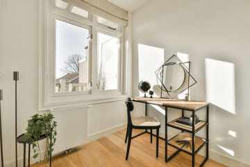 a desk and chair in the corner of a room with a large window looking out onto an outside city view