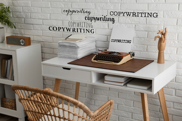 Word Copywriting in different fonts on paper and wall. Workplace with typewriter