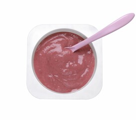 Container with healthy baby food and spoon isolated on white, top view