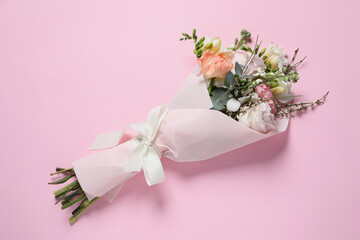 Bouquet of beautiful flowers on pink background, top view