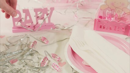 Caucasian Hands Setting Plate on Girl Baby Shower Party Table. Shot with ARRI Alexa in ARRIRAW at 23.98 fps and exported QuickTime Apple ProRes 422 HQ.