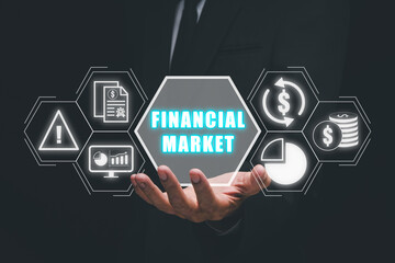 Financial market concept, Business person hand holding financial market icon on virtual screen.