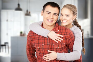 A happy young couple have fun in the living room.
