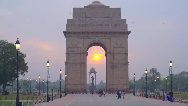 Beautiful sunrise at India Gate on Kartavya Path with tourists and locals enjoying the view, New Delhi, India