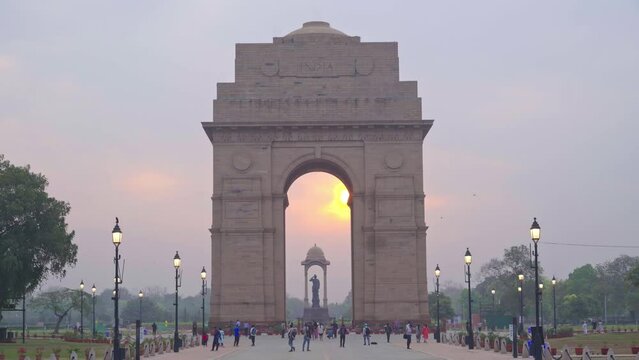 Beautiful sunrise at historical and famous India Gate on Kartavya Path with tourists and locals enjoying the view, New Delhi, India