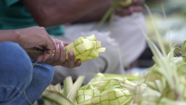 The process of making "Ketupat" nests on the sidewalk of Jalan Kotagede, Yogyakarta. Ketupat is a typical Eid food.