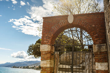 A mediterrean brickwall garden gate in spring outdoors in croatia